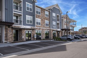 an empty parking lot in front of an apartment building  at Watermark on Twenty Mile, Colorado, 80134